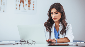 Woman physician at her laptop