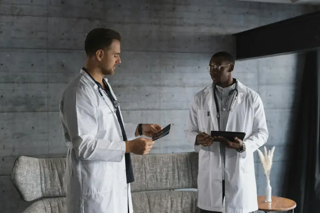 Two doctors in white coats in conversation